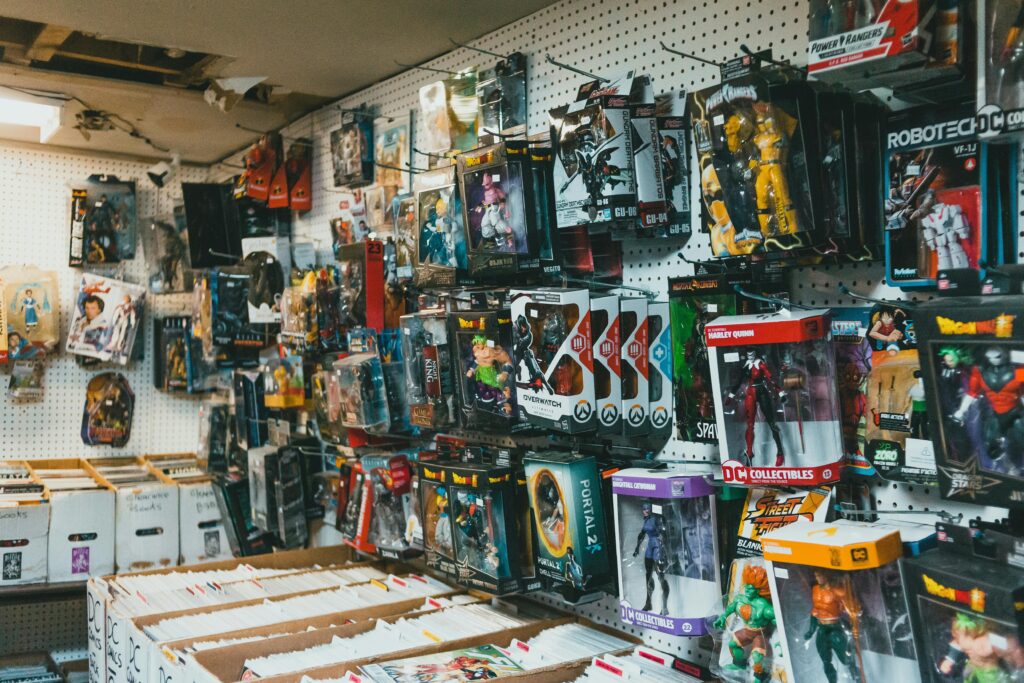 Assorted plastic packages with toy robots and superheroes hanging on metal sticks in shop